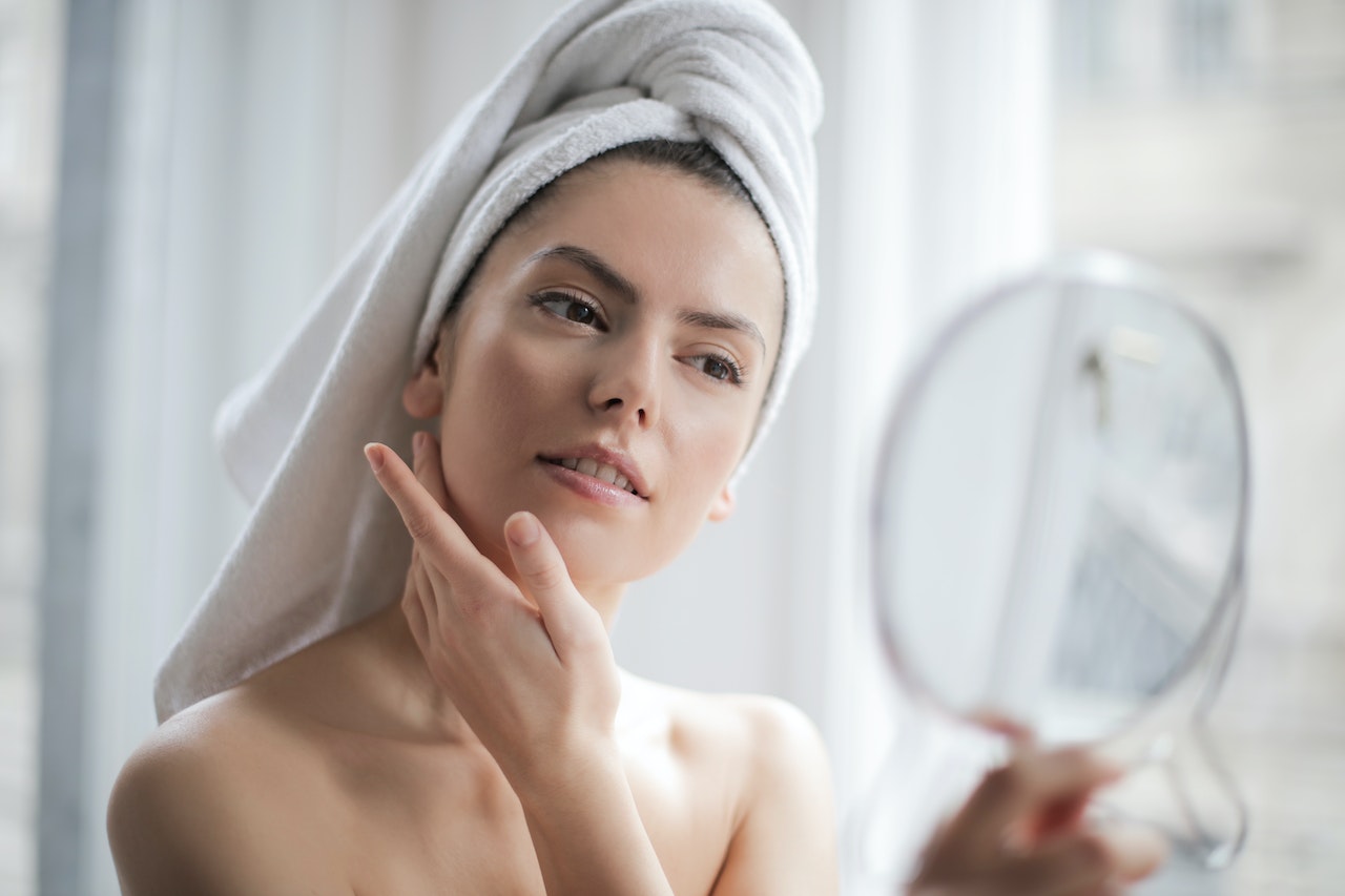 woman looking at mirror